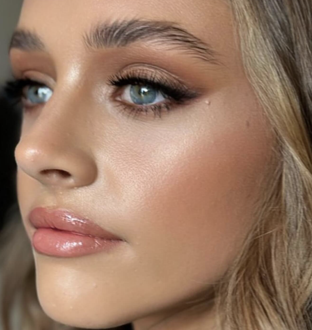 Close-up beauty shot with glowing skin and bronze eyeshadow